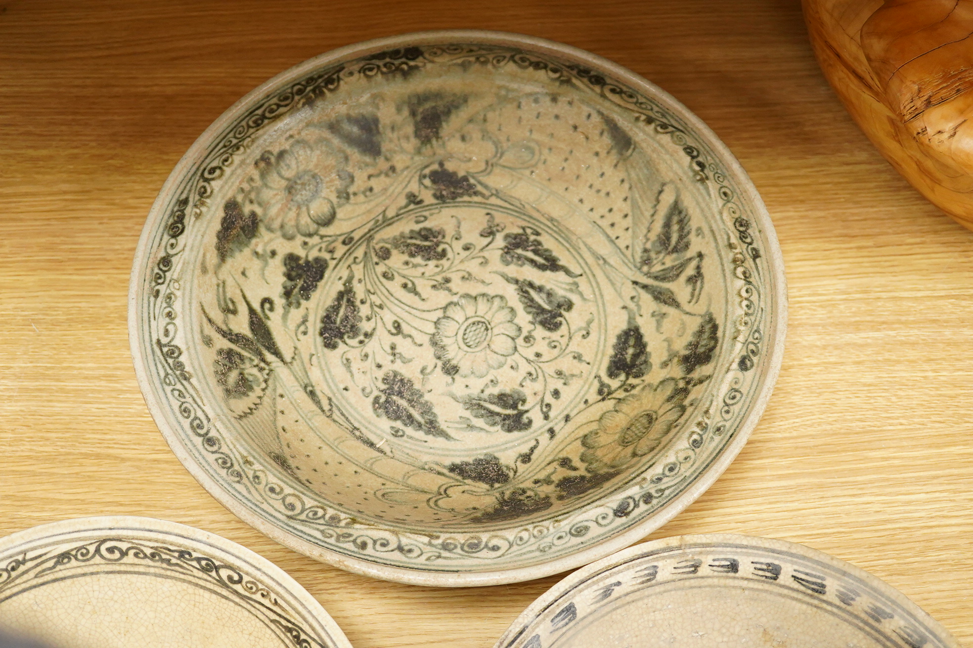 A group of three Thai underglaze blue or black crackle glaze dishes, two decorated with fish, largest 38cm in diameter